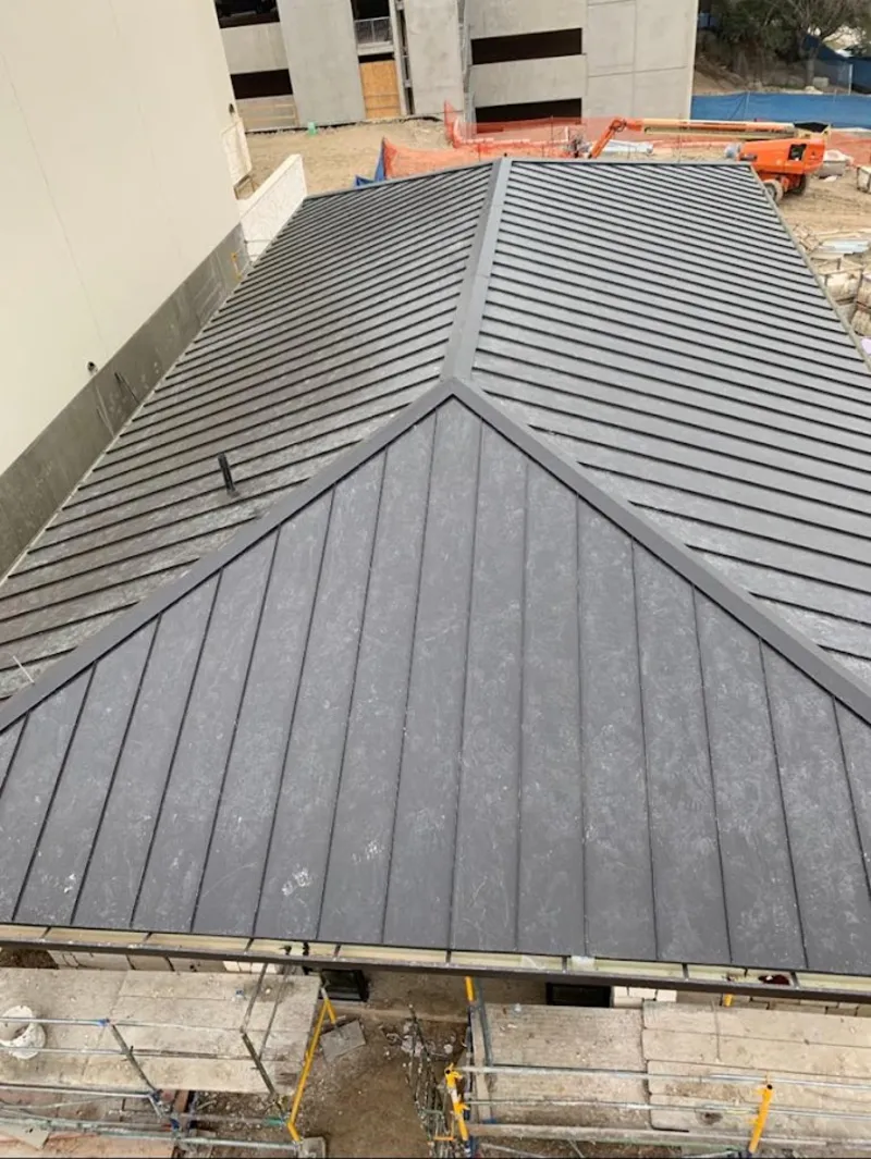 Commercial metal roof construction with crane equipment in Xenia